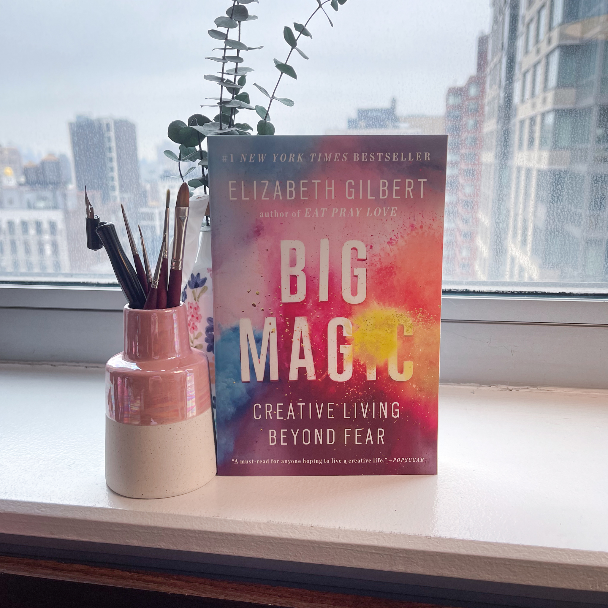 The book "Big Magic" standing upright on a desk