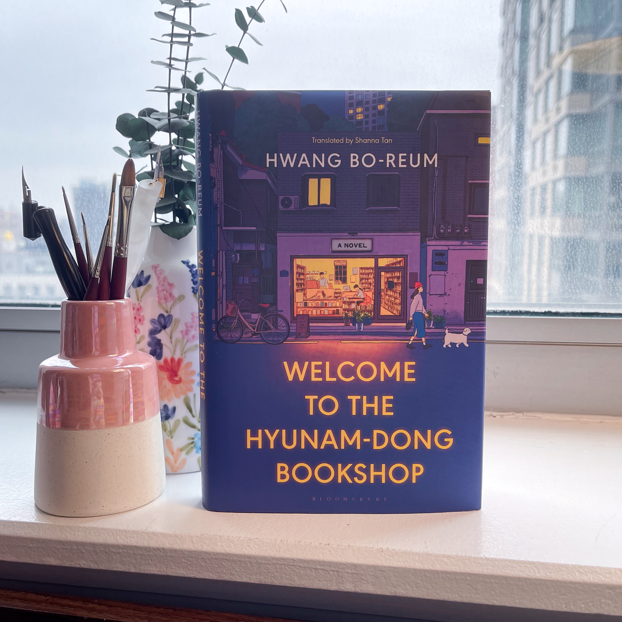 The book "Welcome to the Hyunam-dong Bookshop" standing upright on a desk