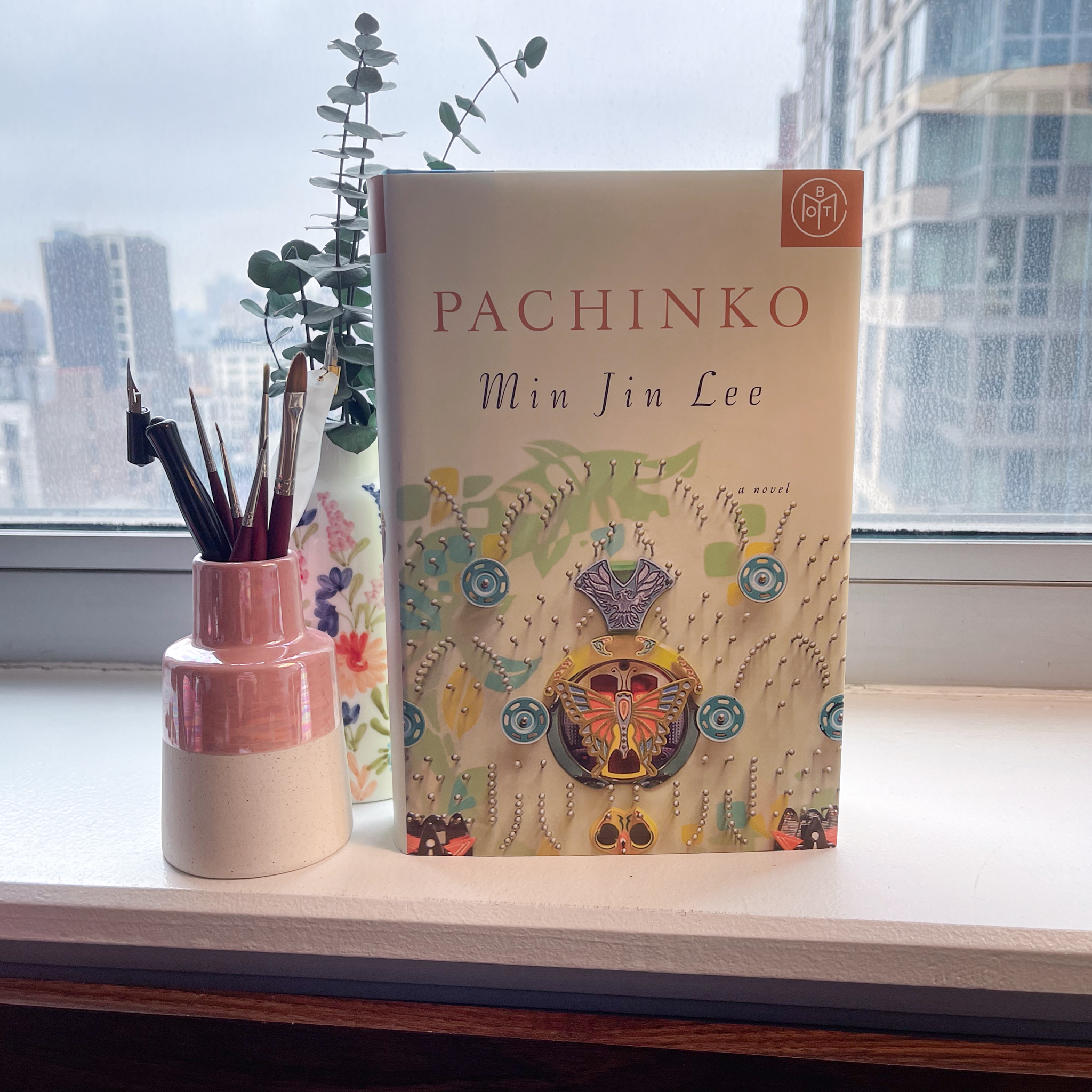 The book "Pachinko" standing upright on a desk